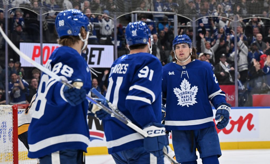 Dec 4, 2024; Toronto, Ontario, CAN;  Toronto Maple Leafs forwards William Nylander (88) and John Tavares (91) acknowledge forward Matthew Knies (23) after his no-look pass set up Nylander for a goal against the Nashville Predators in the third period at Scotiabank Arena. Mandatory Credit: Dan Hamilton-Imagn Images